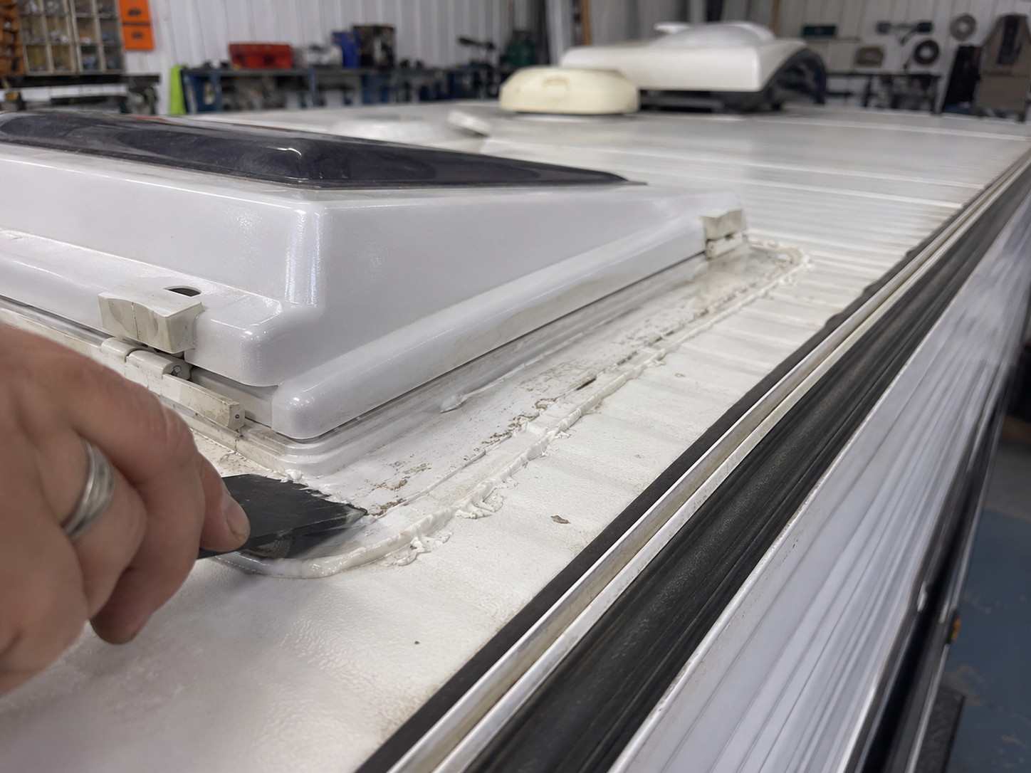 Close-up caravan roof sealant hatch edge and water entry repair area